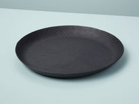 A round, black crosshatch patterned aluminum tray on a light background.